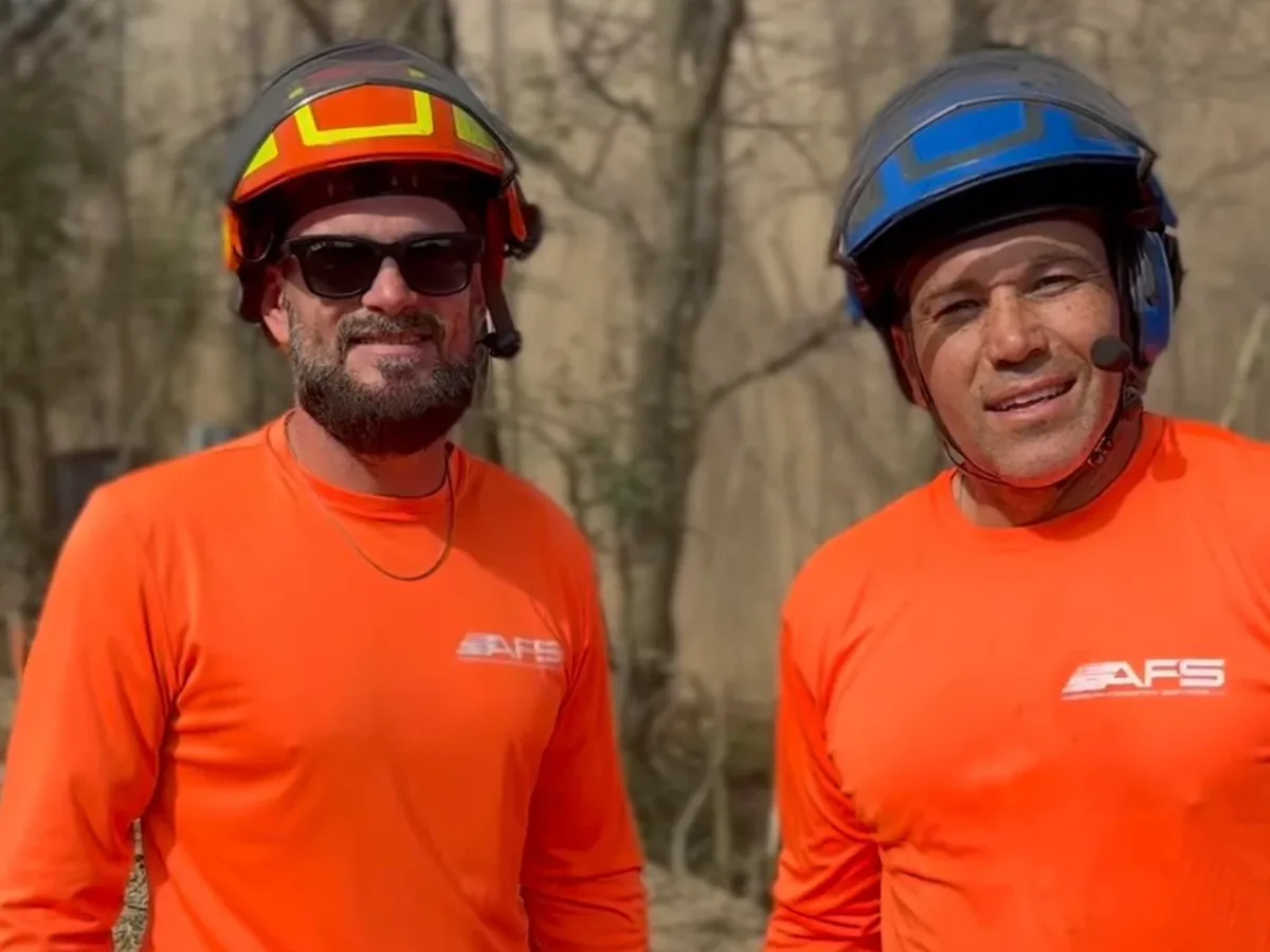 American Forestry Services owners Jeremy (left) and Jason (right) on a tree job in AFS work shirts and climbing helmets